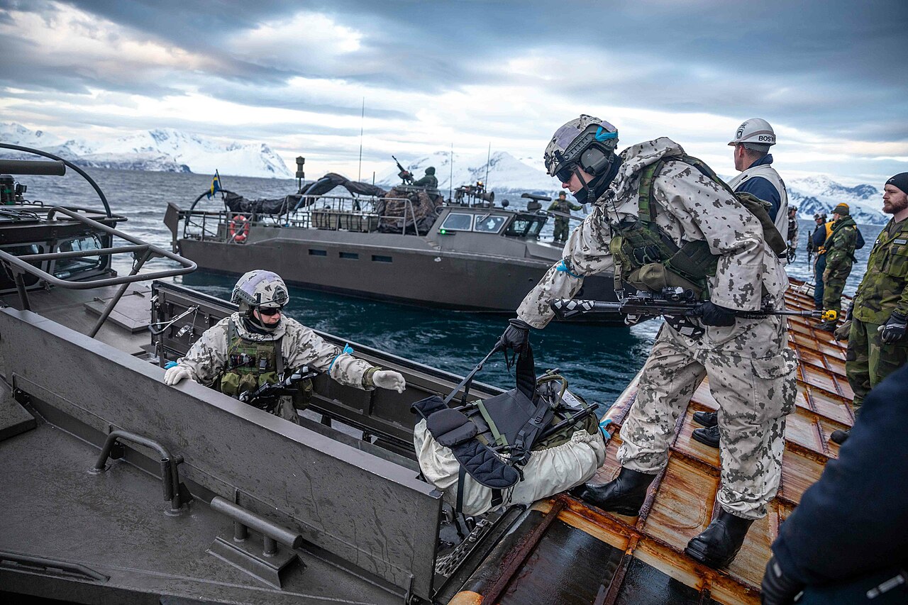 Finnish Marines, assigned to the Nyland Brigade, load gear into a Swedish CB90-class fast assault craft from the stern gate of the Whidbey Island-class dock landing ship USS Gunston Hall (LSD 44), during small boat operations in support of Steadfast Defender 24, March 6, 2024. Steadfast Defender 2024, NATO’s largest exercise in decades, will demonstrate NATO’s ability to deploy forces rapidly from across the Alliance to reinforce the defense of Europe. (U.S. Navy photo by Mass Communication Specialist 1st Class Danielle Serocki)